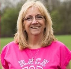Kath in her Race for Life t-shirt showing off her medal.